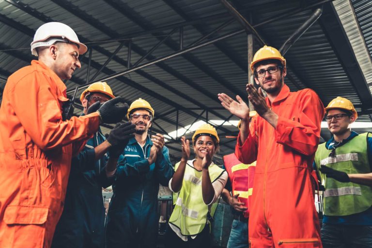 Skillful worker celebrate success in the factory . Industrial people and manufacturing labor concept