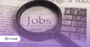 Magnifying glass over a newspaper, highlighting the word JOBS